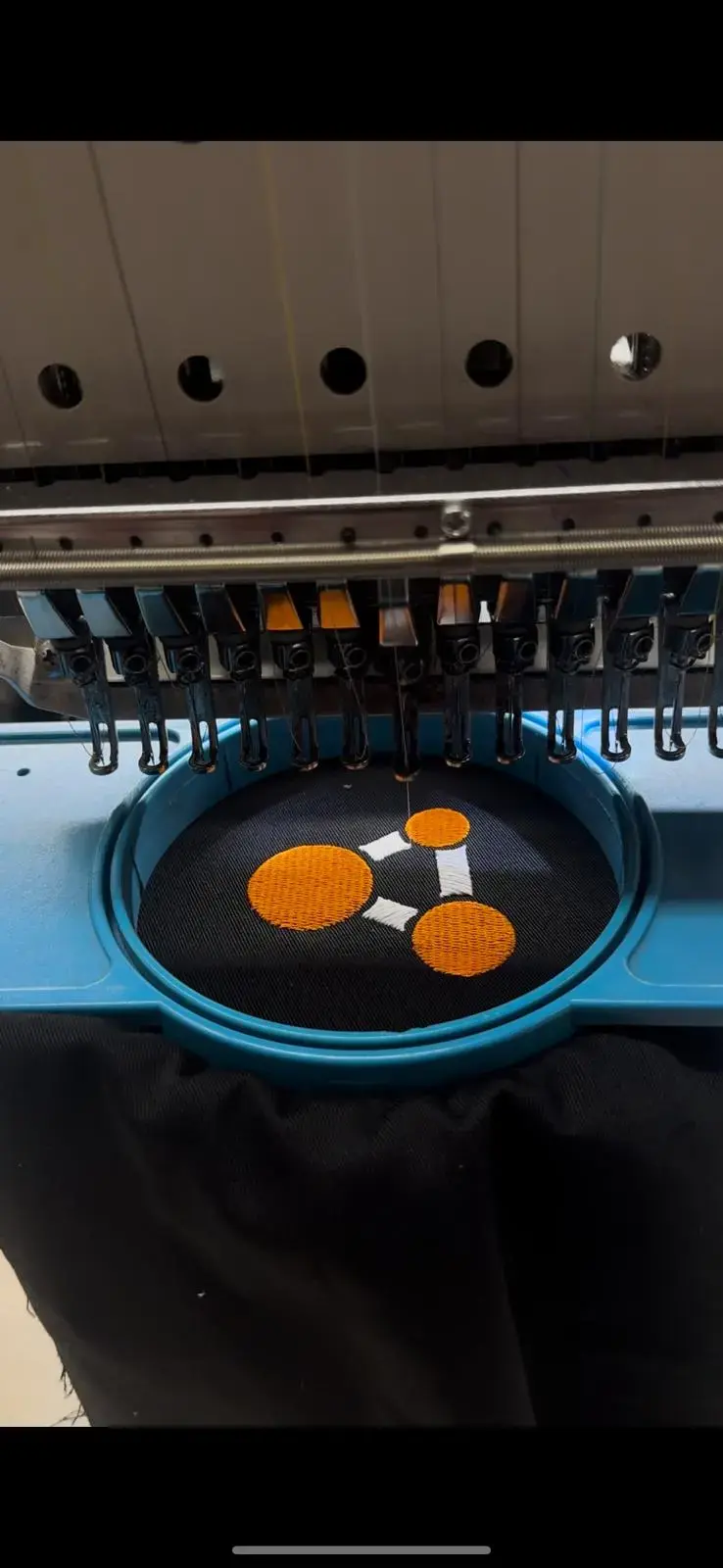 Blue cap embroidered with an orange graphic mark