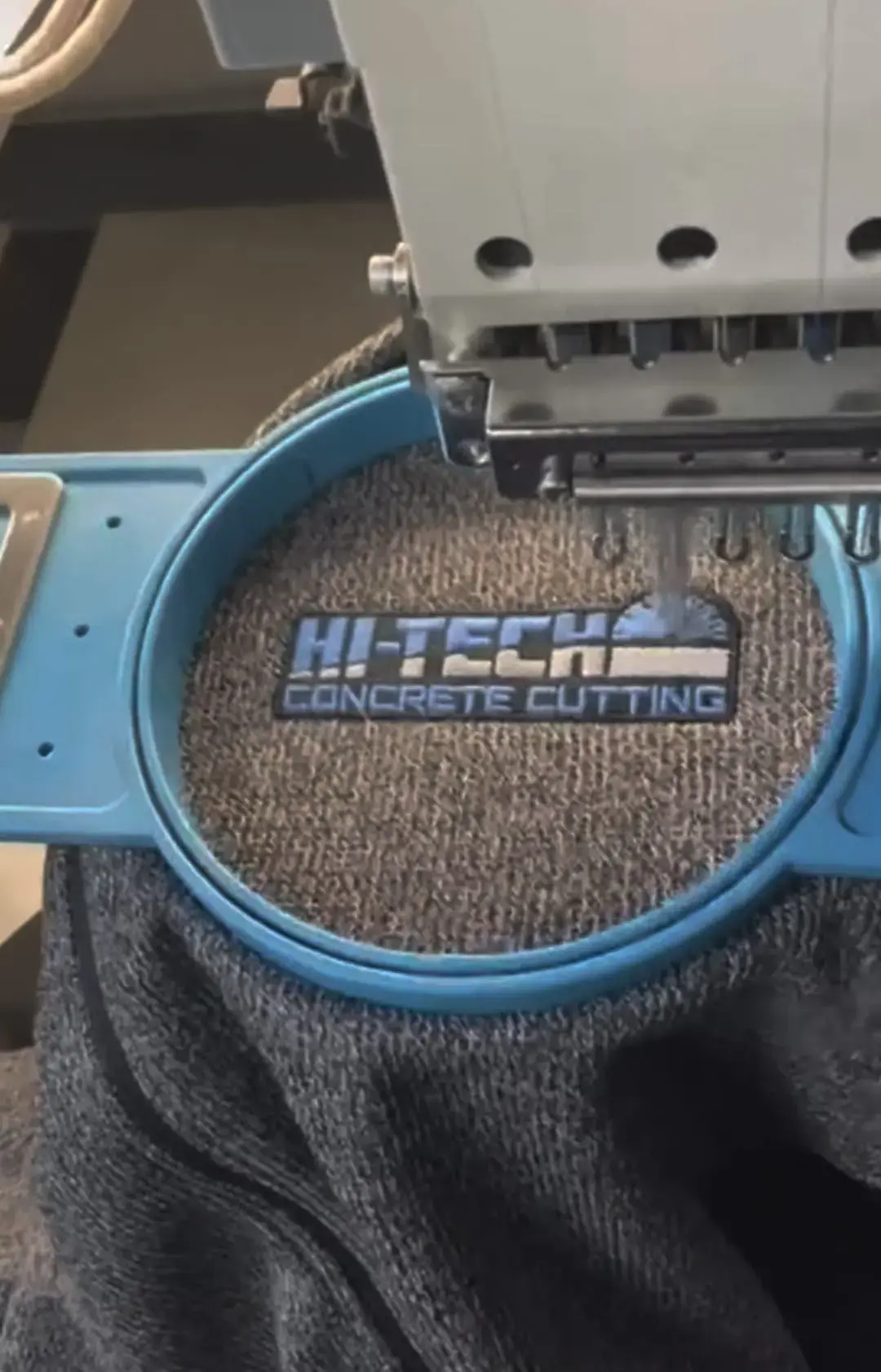 Hi-Tech Concrete Cutting logo embroidered on grey fabric