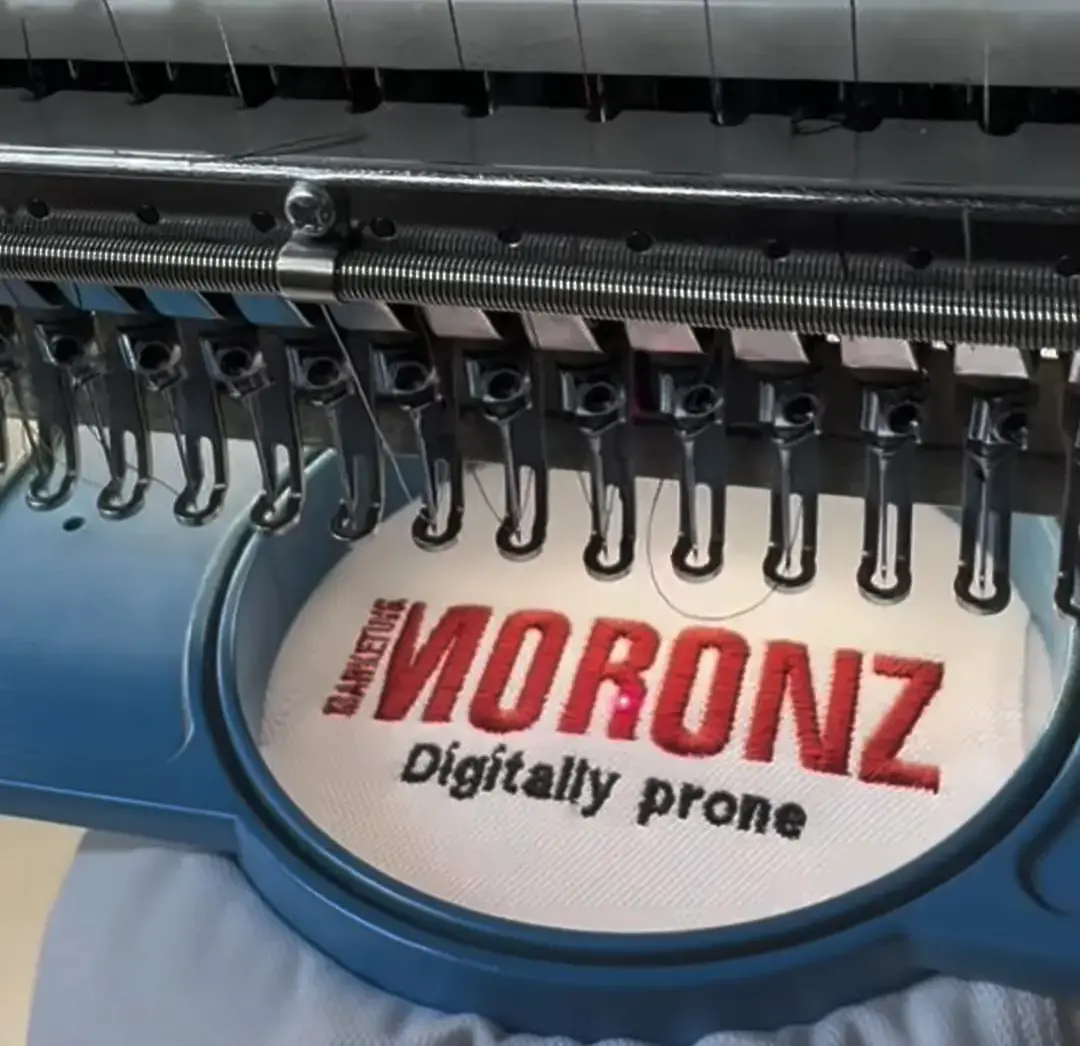 Business logo embroidered onto a black uniform