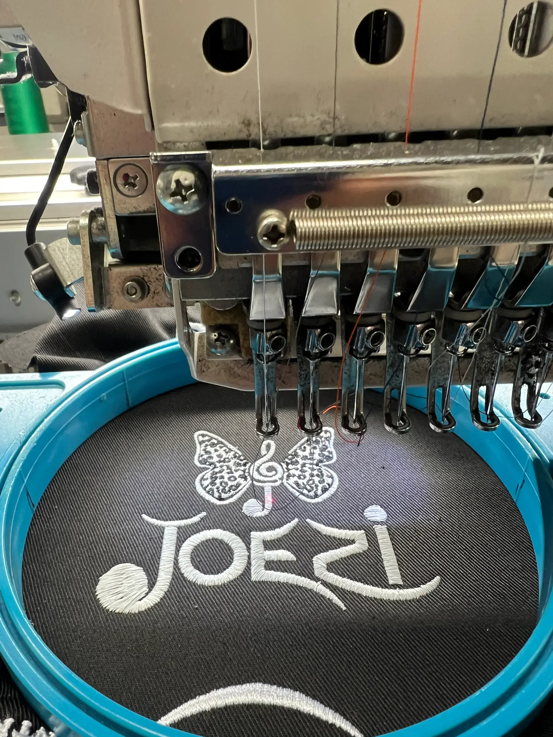 Embroidery machine creating a detailed custom design