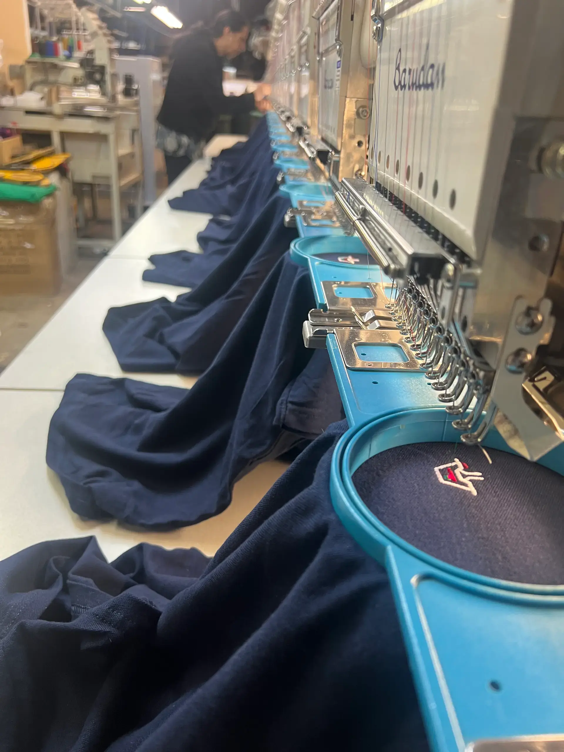 Custom cap positioned under an embroidery machine