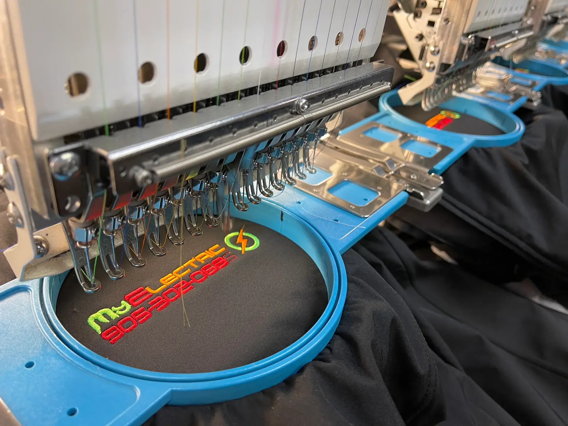 Embroidery machine stitching a colourful custom design