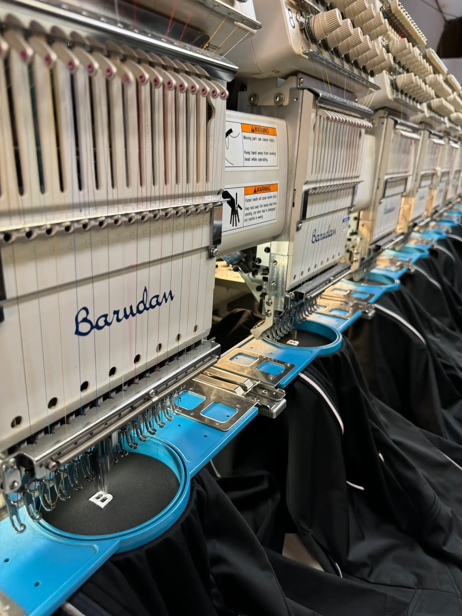 Multiple embroidery machine heads working in the 6iX workshop
