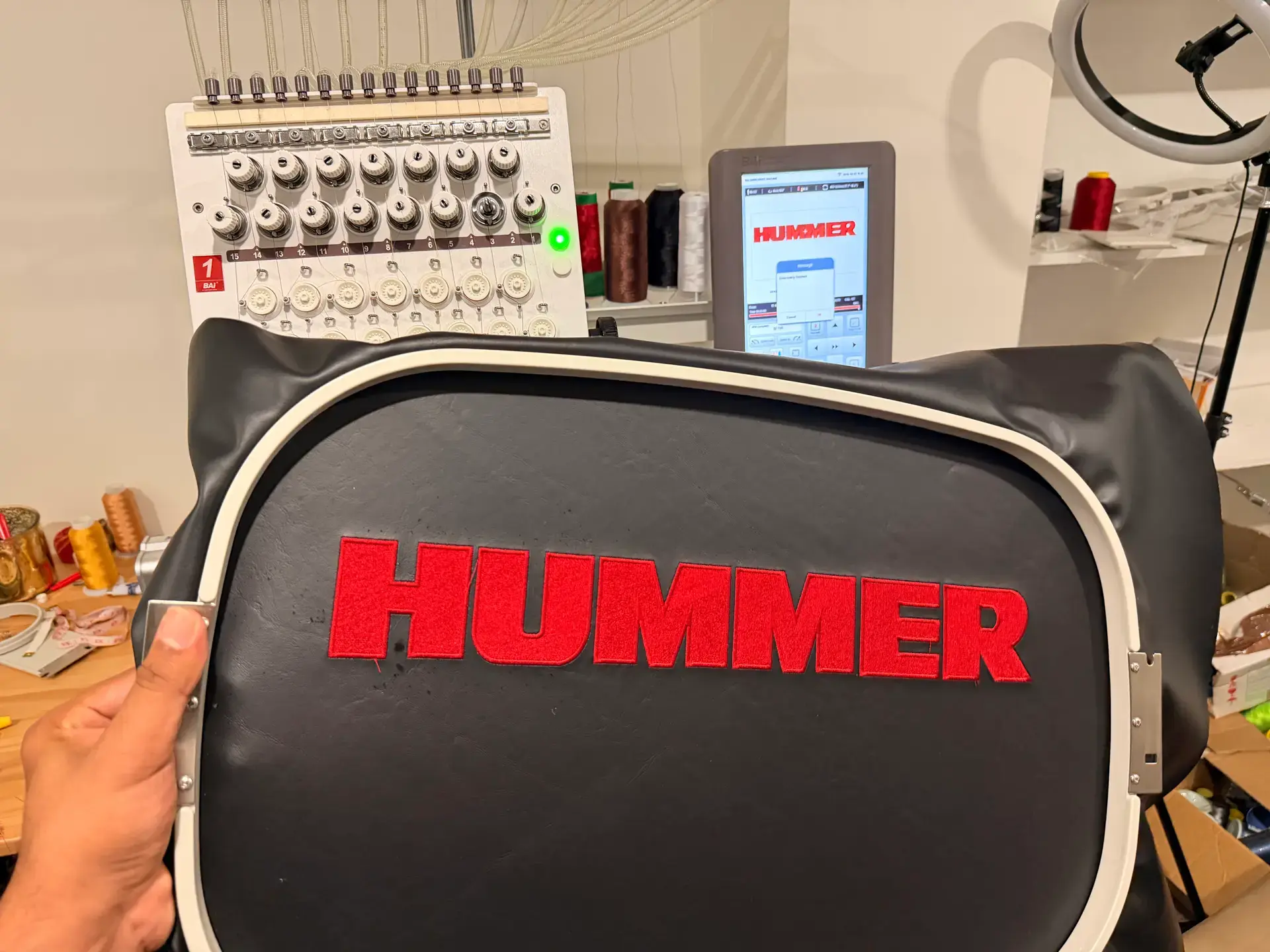 Red HUMMER lettering embroidered on black fabric