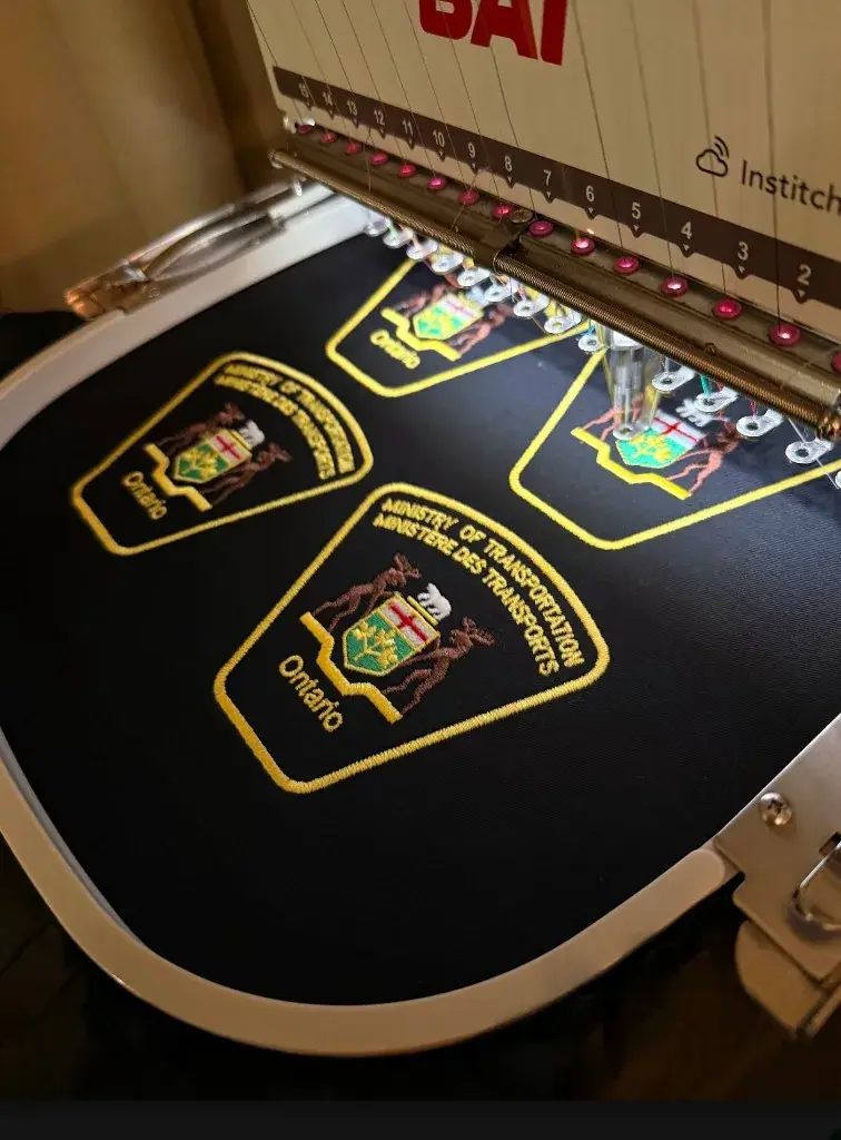 Ontario Ministry of Transportation shoulder patches being embroidered
