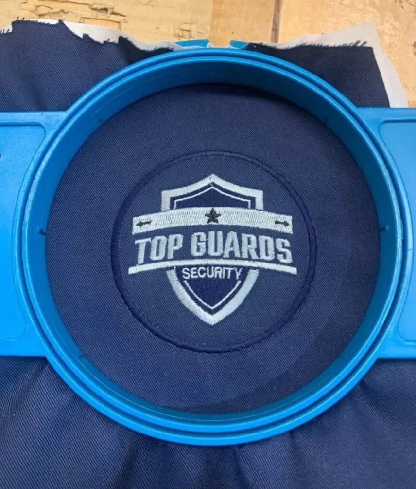 Top Guards Security logo embroidered on navy fabric