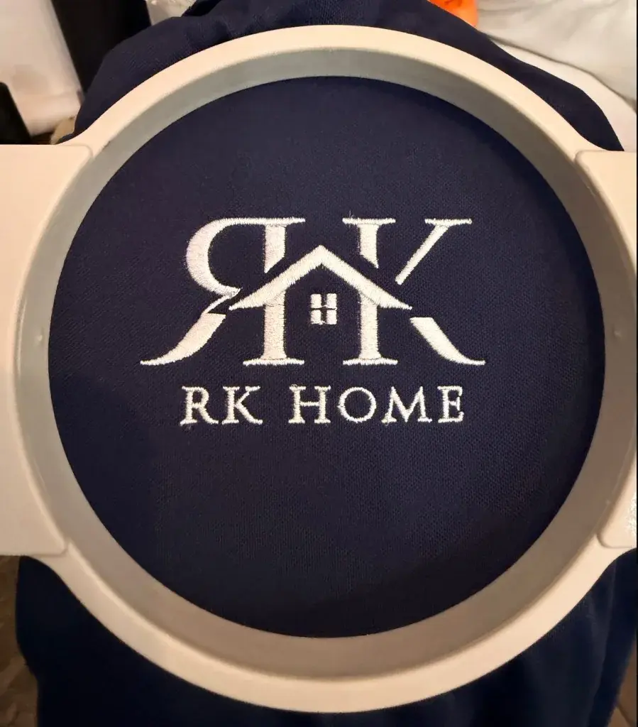 RK Home logo embroidered in white on navy fabric