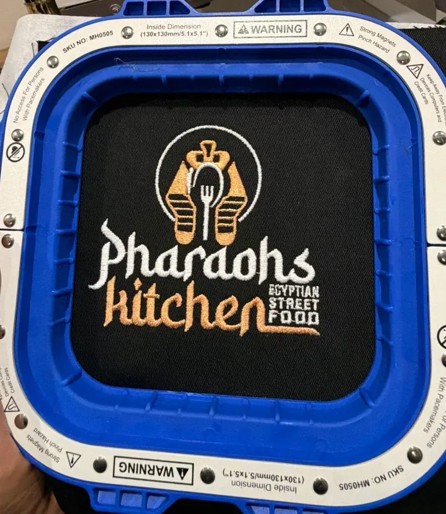 Pharaoh’s Kitchen logo embroidered in gold and white