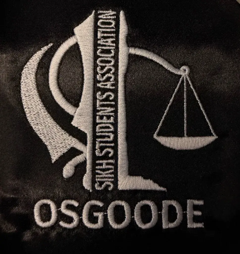Osgoode legal association logo embroidered in white on black fabric